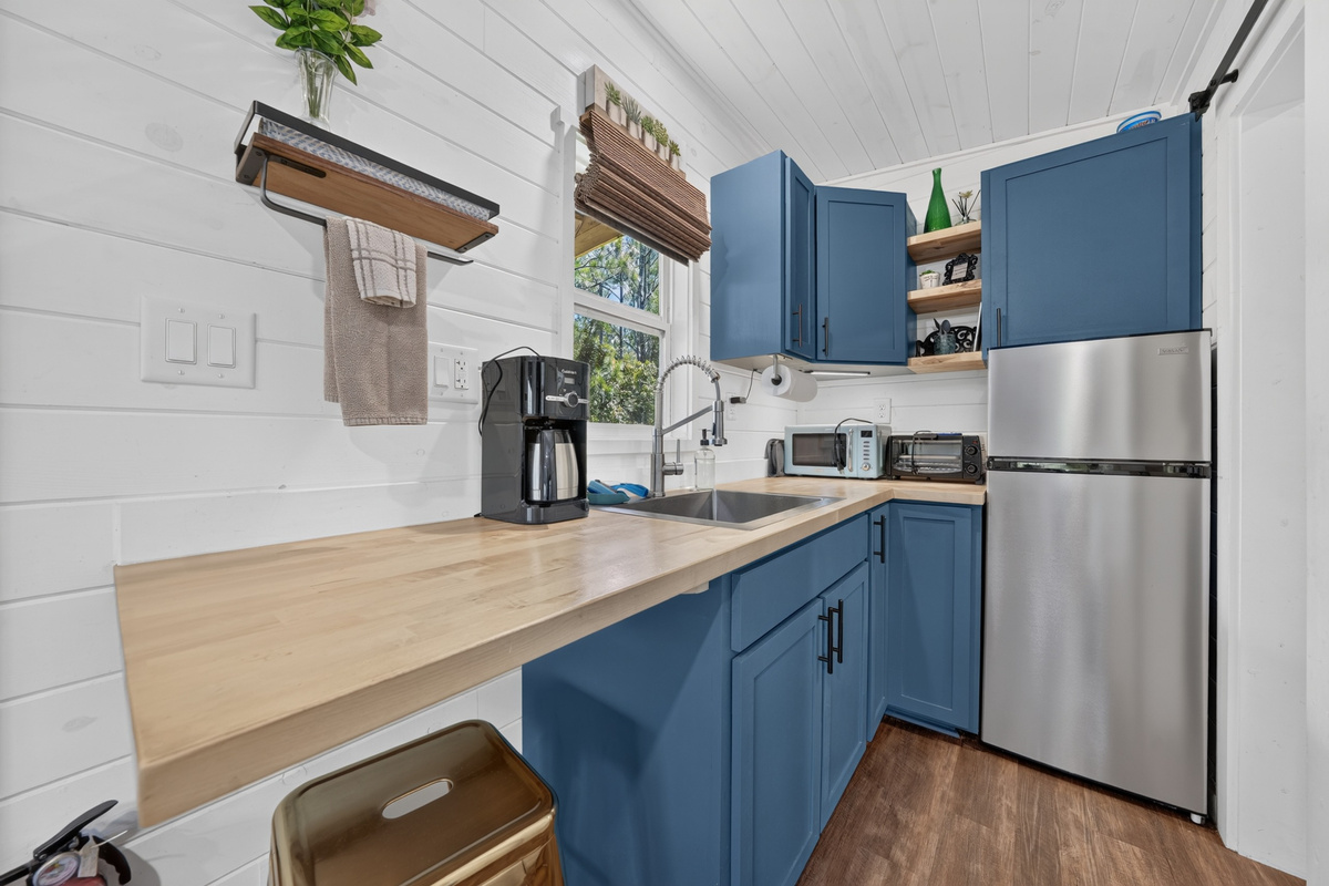Butcher-block counter, refrigerator with freezer, and coffee provided