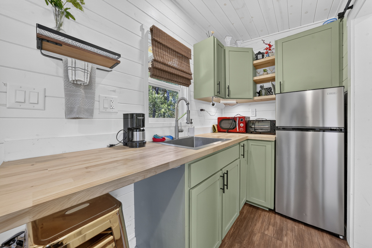 Butcher-block counter with coffee maker, microwave, and toaster oven
