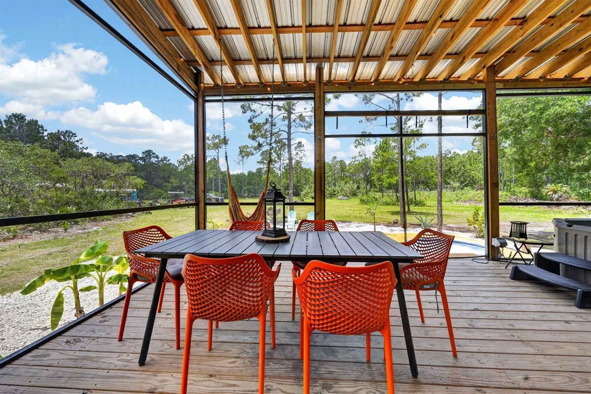 Outdoor dining under cover, set for the group.